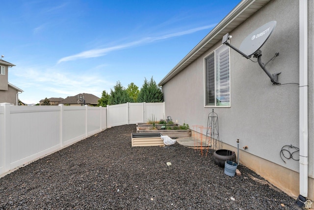 fenced backyard featuring a vegetable garden