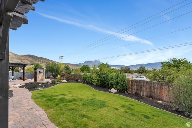 view of yard with a mountain view and a pergola