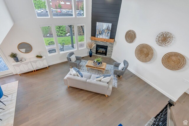 3106 N Eagle Way, Lehi, UT 84043 - living room with a stone fireplace, wood finished floors, baseboards, and a high ceiling