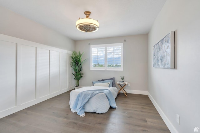 bedroom with wood finished floors and baseboards