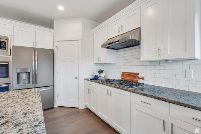 kitchen featuring stainless steel appliances, under cabinet range hood, white cabinets, dark wood-style floors, and recessed lighting