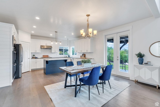 dining area with a chandelier, light wood-type flooring, and recessed lighting
