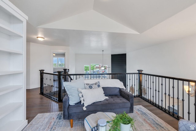 living room featuring wood finished floors and vaulted ceiling