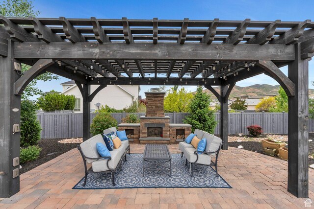 3106 N Eagle Way, Lehi, UT 84043 - view of patio / terrace with an outdoor living space with a fireplace, a fenced backyard, and a pergola