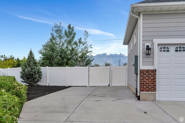 3106 N Eagle Way, Lehi, UT 84043 - garage featuring a gate, fence, and a mountain view