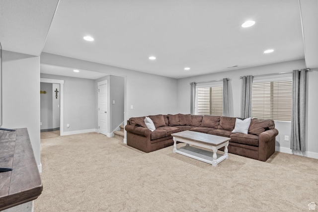 living area with light colored carpet, recessed lighting, baseboards, and stairway