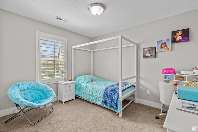 bedroom with carpet flooring, a textured ceiling, and baseboards