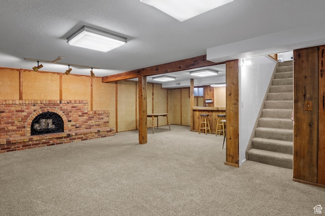 7479 S Randall Cir, Midvale, UT 84047 - below grade area with carpet, stairs, a bar, and a textured ceiling