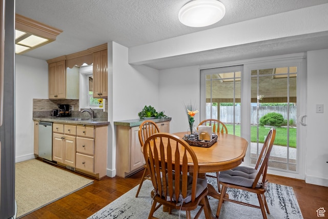 7479 S Randall Cir, Midvale, UT 84047 - dining area featuring dark wood-style floors, a textured ceiling, and baseboards