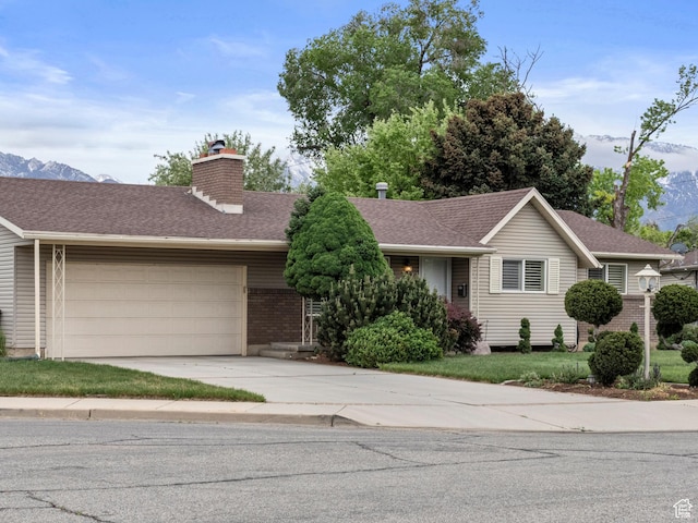 7479 S Randall Cir, Midvale, UT 84047 - ranch-style house featuring a chimney, an attached garage, driveway, brick siding, and roof with shingles