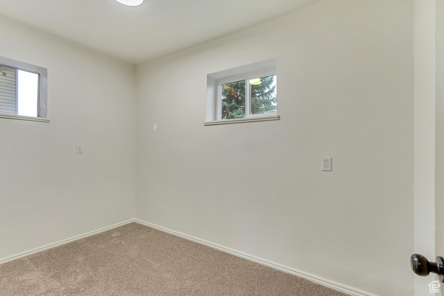 carpeted empty room with baseboards