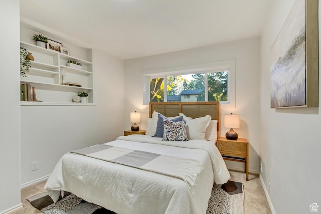 carpeted bedroom featuring baseboards