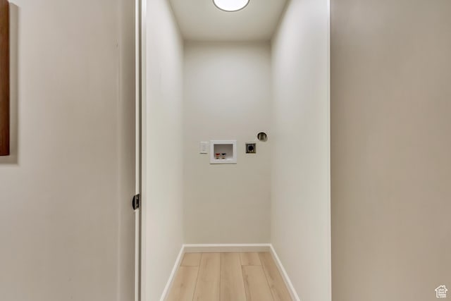 laundry room featuring hookup for an electric dryer, washer hookup, light wood finished floors, and baseboards
