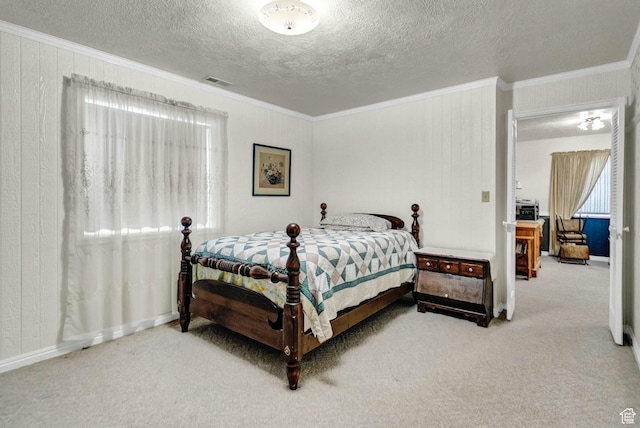 carpeted bedroom featuring crown molding, a textured ceiling, and baseboards