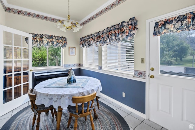 tiled dining area featuring a chandelier