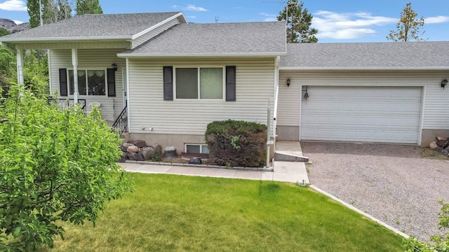 view of front of home featuring driveway, an attached garage, a front lawn, and a shingled roof