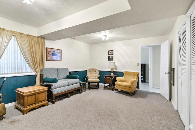 sitting room featuring carpet and baseboards