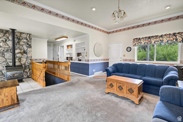 living room featuring a chandelier, a wood stove, light carpet, and ornamental molding