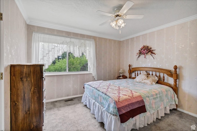 carpeted bedroom featuring baseboards, crown molding, and ceiling fan