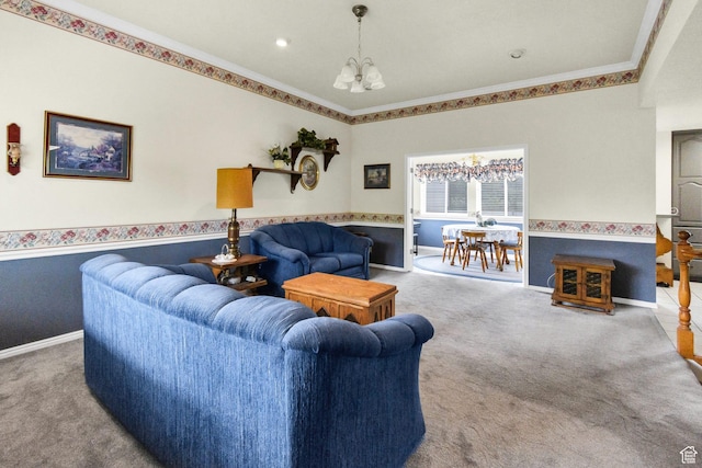 living room with a chandelier, carpet flooring, crown molding, and baseboards