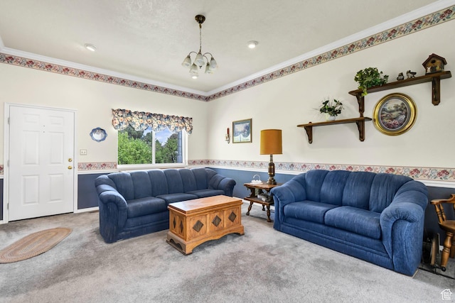 carpeted living room featuring crown molding and a chandelier