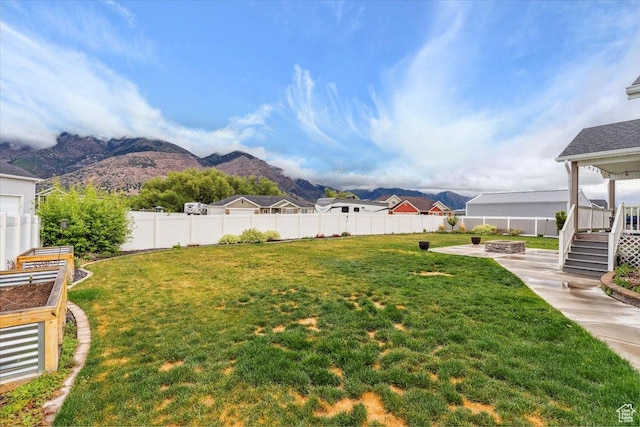 1254 N 150 E, Harrisville, UT 84404 - view of yard featuring an outdoor fire pit, a patio area, a mountain view, and a garden