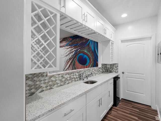 3388 W Rocky Peak Way S, Jordan, UT 84095 - kitchen with a sink, white cabinetry, backsplash, light stone countertops, and dark wood-style floors
