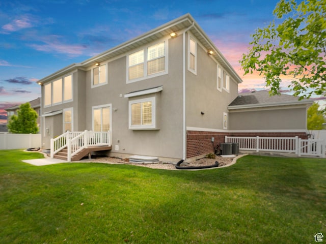 3388 W Rocky Peak Way S, Jordan, UT 84095 - rear view of property with stucco siding, brick siding, and central AC unit