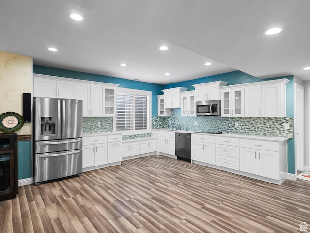 3388 W Rocky Peak Way S, Jordan, UT 84095 - kitchen featuring black appliances, light countertops, light wood-type flooring, white cabinets, and recessed lighting