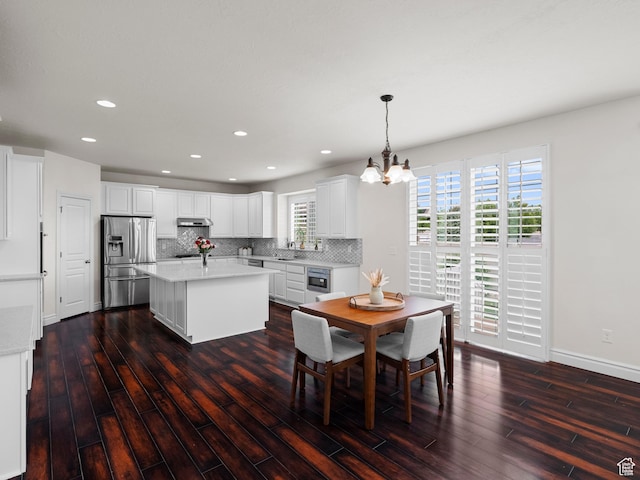 3388 W Rocky Peak Way S, Jordan, UT 84095 - dining area featuring a chandelier, dark wood-style flooring, recessed lighting, and baseboards