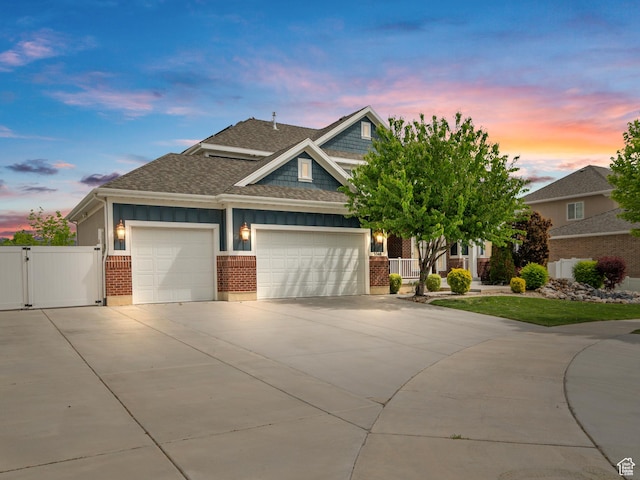 3388 W Rocky Peak Way S, Jordan, UT 84095 - craftsman-style house featuring roof with shingles, a gate, driveway, an attached garage, and brick siding