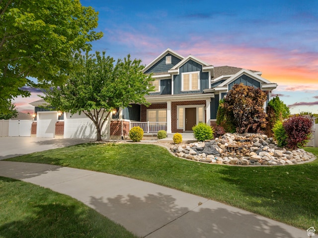 3388 W Rocky Peak Way S, Jordan, UT 84095 - view of front of property with covered porch, driveway, brick siding, and a garage