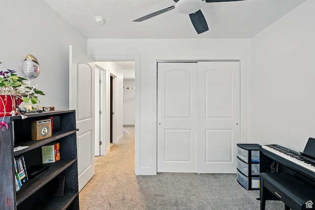 home office featuring carpet and a ceiling fan