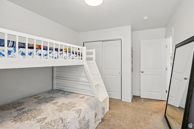 unfurnished bedroom with carpet floors and a closet