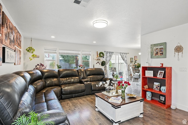 living room with wood finished floors and recessed lighting