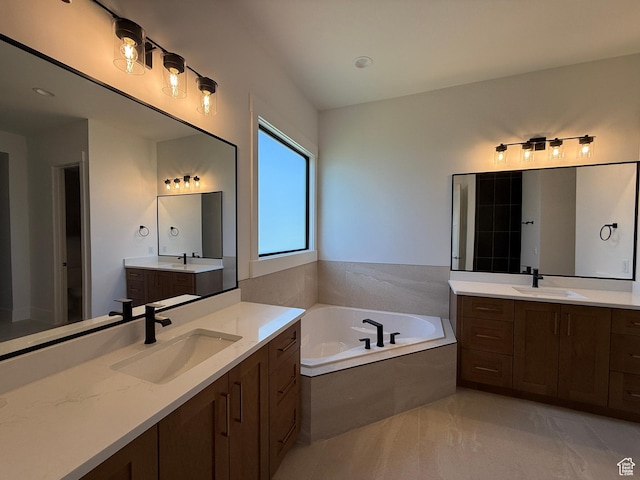 full bath with a bath and two vanities