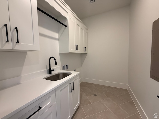 laundry area featuring cabinet space, hookup for a washing machine, hookup for an electric dryer, baseboards, and light tile patterned floors