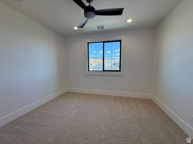 spare room with ceiling fan, baseboards, recessed lighting, and light colored carpet