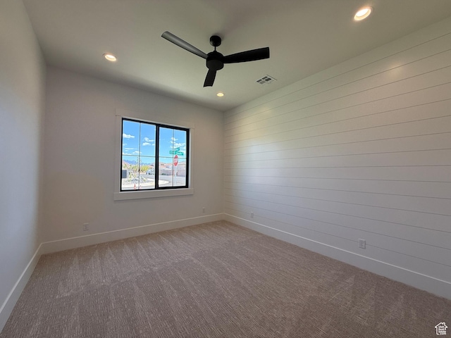 carpeted empty room featuring ceiling fan, recessed lighting, and baseboards
