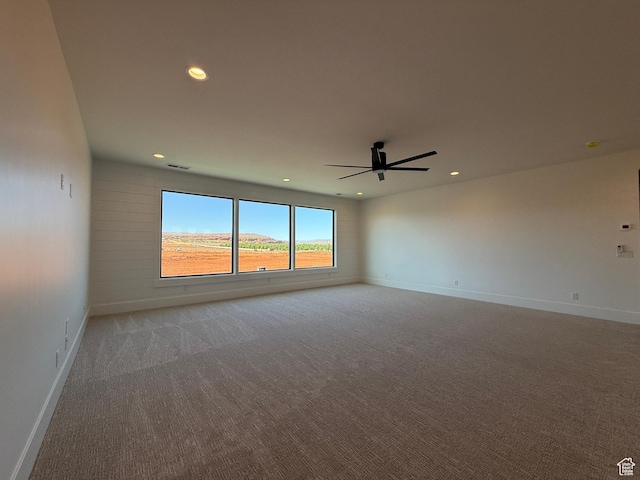 carpeted empty room with recessed lighting, a ceiling fan, and baseboards