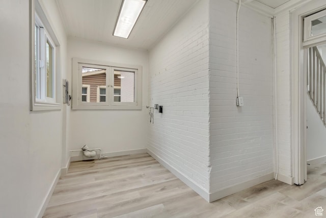 915 W 300 S, Salt Lake City, UT 84104 - clothes washing area featuring baseboards, light wood-style flooring, and brick wall
