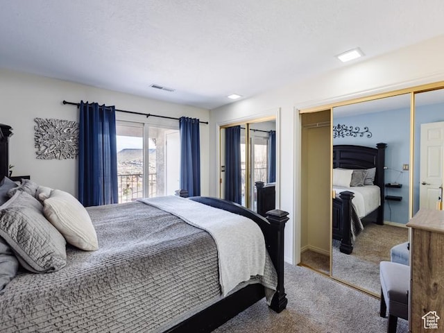 carpeted bedroom with multiple closets and baseboards