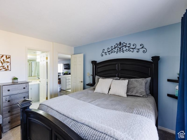 bedroom with light colored carpet and ensuite bath