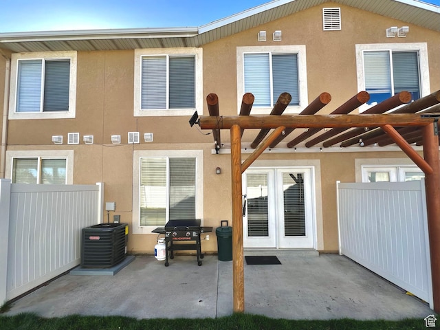back of house featuring a patio, fence, and stucco siding
