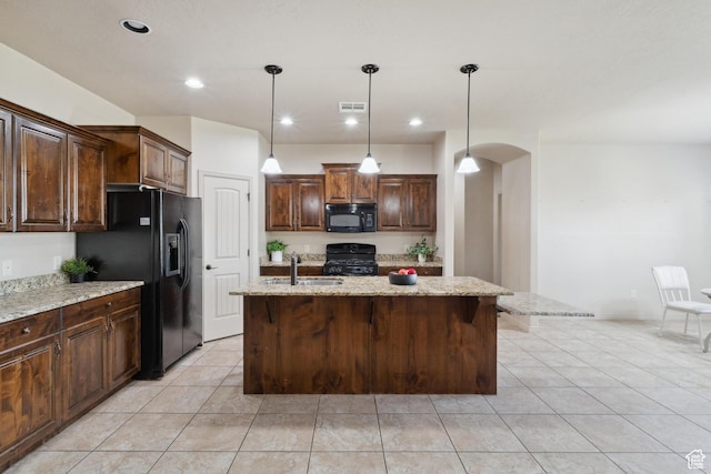 417 E Stonehedge Cir, Washington, UT 84780 - kitchen featuring black appliances, a sink, light tile patterned floors, arched walkways, and light stone countertops