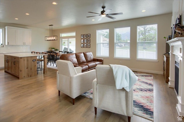 352 N 75 E, Kaysville, UT 84037 - living area with plenty of natural light, light wood-style floors, a ceiling fan, recessed lighting, and a fireplace
