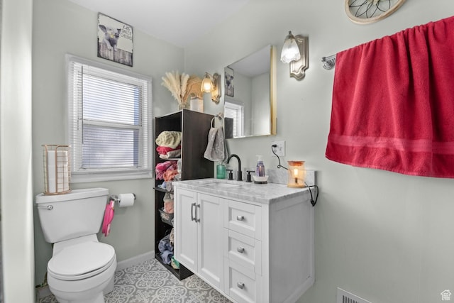 8521 W 3100 S, Magna, UT 84044 - bathroom with healthy amount of natural light, vanity, baseboards, and toilet