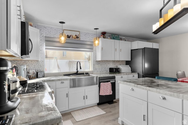 8521 W 3100 S, Magna, UT 84044 - kitchen featuring stainless steel appliances, a sink, light countertops, white cabinets, and decorative backsplash
