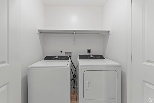 clothes washing area featuring washer and dryer