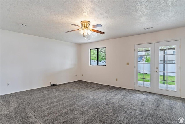 carpeted empty room with french doors, a ceiling fan, and a textured ceiling